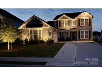 Charming two-story home with landscaped yard illuminated in the evening at 5043 Baileys Run Dr, Rock Hill, SC 29732
