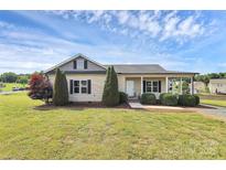 Charming single-story home featuring a cozy front porch and well-manicured landscaping at 5333 Lake Glenn Dr, Stanfield, NC 28163