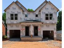 New construction home featuring a modern design with a covered front porch and attached garages at 5615 Lantana Ave # B, Charlotte, NC 28205