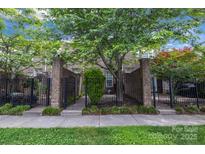 Charming brick townhome with a well-manicured lawn and mature trees in a desirable location at 6011 Nw Village Nw Dr, Concord, NC 28027