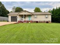 Charming ranch home with a well-manicured lawn and inviting curb appeal at 667 Blossom Hill Rd, Lincolnton, NC 28092