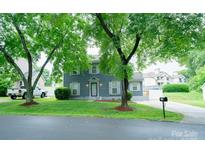 Charming two-story home with a well-manicured lawn, mature trees, and inviting curb appeal at 8125 Sheringham Way, Charlotte, NC 28227