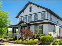 Two-story home with white siding, black trim, landscaped front yard, and welcoming porch at 909 Herrons Ferry Rd, Rock Hill, SC 29730