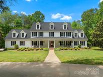 Stately two-story home with black shutters, dormer windows, and a welcoming front porch at 1010 Arabian Farm Rd, Clover, SC 29710