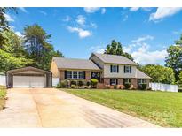 Charming two-story home featuring a well-manicured lawn, a carport, and inviting curb appeal at 1104 Colony Ct, Gastonia, NC 28056