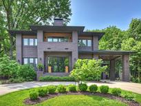 Stunning two-story brick home with manicured landscaping and covered parking at 112 Manning Dr, Charlotte, NC 28209