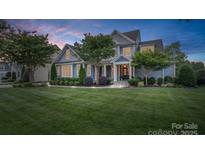 Charming two-story home with a well-manicured lawn and beautiful landscaping at 118 Tuscany Trl, Mooresville, NC 28117