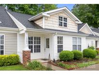 Charming home with landscaped front yard, brick accents, and covered porch, perfect for relaxing outdoors at 1305 Dan Dr, Rock Hill, SC 29732