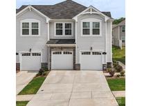 Beautiful townhome exterior featuring attached garages and manicured landscaping in a desirable neighborhood at 13327 Savaine St, Charlotte, NC 28278