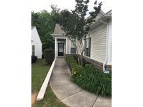 Inviting front entrance with a well-manicured lawn, trimmed bushes, and an elegant black front door at 19157 Mallard Dr, Fort Mill, SC 29707