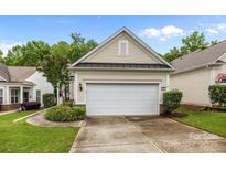 Attached one car garage with siding, black gutters, fresh landscaping, and concrete drive at 19157 Mallard Dr, Fort Mill, SC 29707