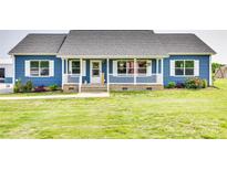 Charming single-story home featuring blue siding, a welcoming front porch, and a well-manicured lawn at 2268 Westbrook Rd, Edgemoor, SC 29712
