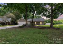 Charming single-story home featuring a well-maintained front yard and attached garage at 3807 Sweetgrass Ln, Charlotte, NC 28226