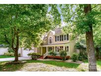 Charming two-story home featuring a welcoming front porch and lush, mature landscaping at 4333 Poplar Grove Dr, Charlotte, NC 28269