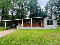 Charming single-story home with a carport and a well-maintained front lawn at 4524 Cinderella Rd, Charlotte, NC 28213