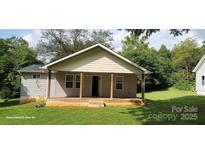 Charming single-story home with a welcoming front porch and well-maintained lawn at 608 E E St, Newton, NC 28658