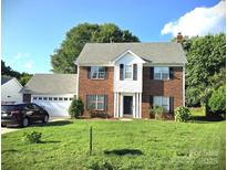 Charming brick two-story home with a well-manicured lawn and attached two-car garage at 6821 Millingden Ct, Charlotte, NC 28277