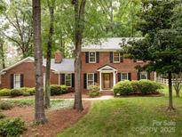 Charming brick home with black shutters and manicured landscaping at 8201 Lansford Rd, Charlotte, NC 28277