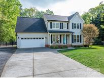 Beautiful two-story home with an attached garage, a well-maintained lawn, and a welcoming front porch at 107 Ingonish Dr, Gastonia, NC 28056