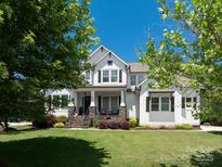 Charming two-story white home with a welcoming front porch and lush green lawn at 1085 Wessington Manor Ln, Fort Mill, SC 29715