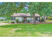 Charming single-story home with a well-maintained lawn, complemented by mature trees for shade at 2009 Pinevalley Rd, Rock Hill, SC 29732