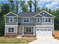 Charming two-story home with stone accents, a two-car garage, and a well-manicured lawn at 236 Mountain Island Rd # 40, Statesville, NC 28677