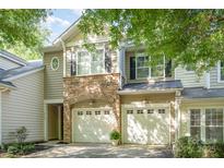 Charming townhome featuring a stone facade and two-car garage for convenient parking at 2548 Chasewater Dr, Indian Land, SC 29707