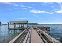 Lake house with a private dock and covered boat slip for easy access to water activities at 392 Stonemarker Rd, Mooresville, NC 28117