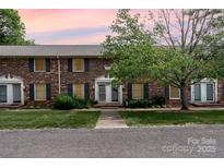 Charming brick townhome featuring a well-manicured lawn and a welcoming front entrance at 4329 Hathaway St # D, Charlotte, NC 28211
