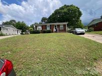 Charming one-story brick home featuring a well-manicured front yard and inviting entrance at 4414 Birkdale Dr, Charlotte, NC 28208