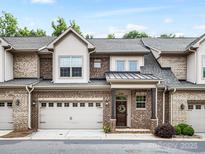 Beautiful brick townhome with an attached garage and a covered front entrance at 5030 Waldron Meadow Dr, Charlotte, NC 28226