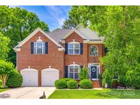 Charming two-story brick home featuring a manicured lawn, two-car garage, and inviting front entrance at 701 Larkridge Ct, Rock Hill, SC 29730
