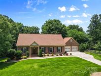 Well-maintained brick home with a manicured lawn and a two car garage at 7916 Wellston Dr, Charlotte, NC 28210