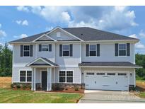 Charming two-story home with gray siding, black shutters and an attached two car garage at 115 Kerr Walk Dr # 37, Statesville, NC 28677