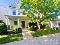 Charming two-story home with a welcoming front porch and mature landscaping at 11624 Truan Ln, Cornelius, NC 28031