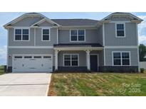 Charming two-story home featuring a two-car garage and a welcoming front porch, offering a blend of comfort and modern design at 118 Kerr Walk Dr # 17, Statesville, NC 28677