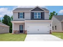Charming two-story home with a modern design, attached two-car garage, and well-manicured lawn at 1508 Doran Ter, Richburg, SC 29729