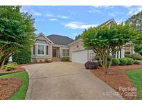 Charming home featuring a well-maintained lawn and a welcoming driveway at 17308 Players Ridge Dr, Cornelius, NC 28031