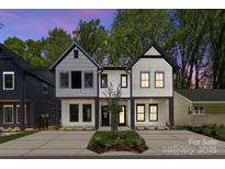 Beautiful new construction features a modern facade, fresh landscaping, and a spacious driveway at 2004 St John St, Charlotte, NC 28216