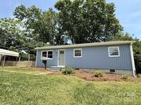 Charming one story home with blue siding, green lawn, and mature trees at 408 N Hill St, Dallas, NC 28034