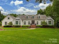 Sprawling single story home featuring well manicured yard, dormer windows, and symmetrical design elements at 4201 Quail Hunt Ln, Charlotte, NC 28226