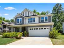 Beautiful two-story home featuring a gray exterior, a two-car garage, and a well-manicured front lawn at 5088 Watersail Way, Clover, SC 29710