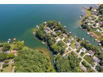 Stunning aerial view of lakefront homes with private docks surrounded by lush trees and sparkling water at 5153 Glenwood St, Sherrills Ford, NC 28673