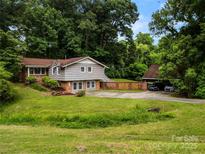 Charming home with a lush, green lawn and a detached two-car carport at 607 Coulwood Dr, Charlotte, NC 28214