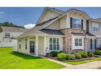 Charming townhome with stone accents, a well-manicured lawn, and a welcoming front porch at 841 Lacebark Dr, Rock Hill, SC 29732