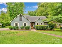 Charming single-story home with lush front yard, well maintained landscaping, and sidewalk at 8506 Graham Rd, Denver, NC 28037