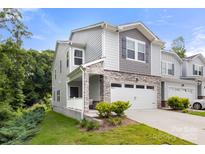 Charming two-story home with stone accents, neutral siding, a two car garage and manicured landscaping at 1028 Maltby St, Charlotte, NC 28217