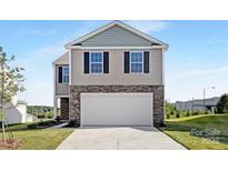 Two-story home featuring stone accents, a two-car garage, neutral siding, and a well manicured lawn at 1039 20Th Avenue Se Loop, Hickory, NC 28602