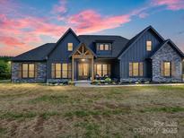 Inviting two-story home featuring stone accents, modern siding, large windows, and a beautifully landscaped front yard at 1172 Springlake Rd, York, SC 29745