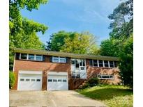 Charming brick home with a two-car garage and beautifully landscaped front yard, offering great curb appeal at 1525 16Th Avenue Nw Cir, Hickory, NC 28601